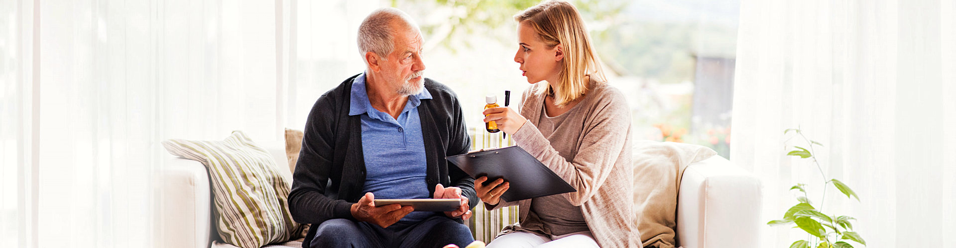 caregiver having a discussion with her senior patient